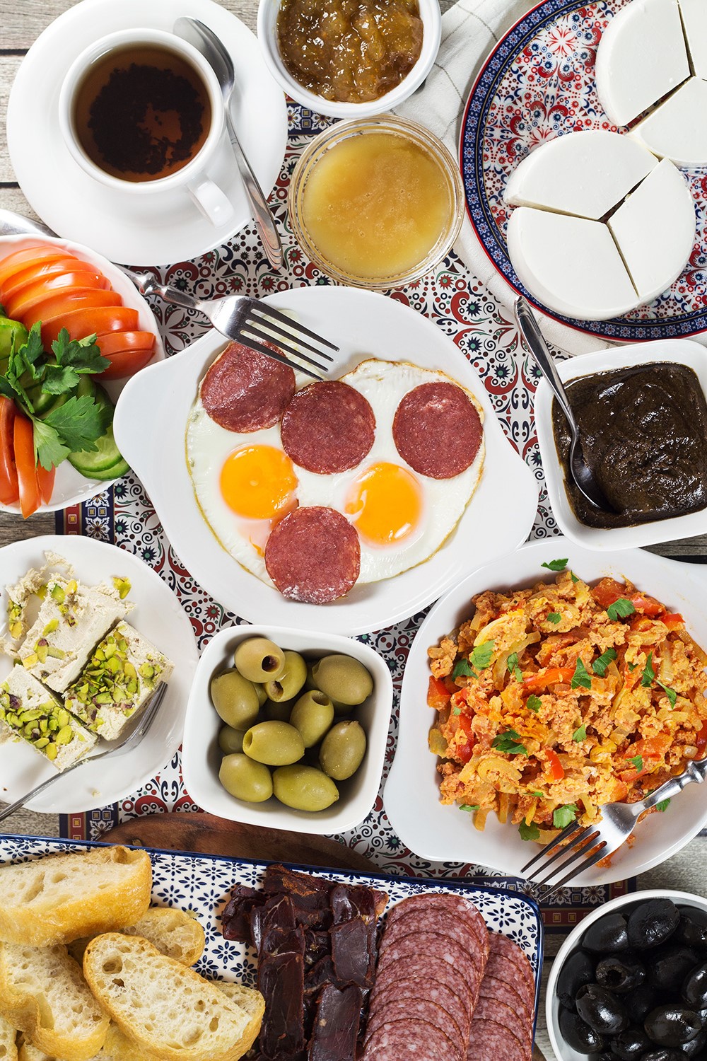 A look at the generous Turkish breakfast which features fresh bread, pastries, cold cuts, eggs, spreads, jams, cheese, veggies, and more! | cookingtheglobe.com