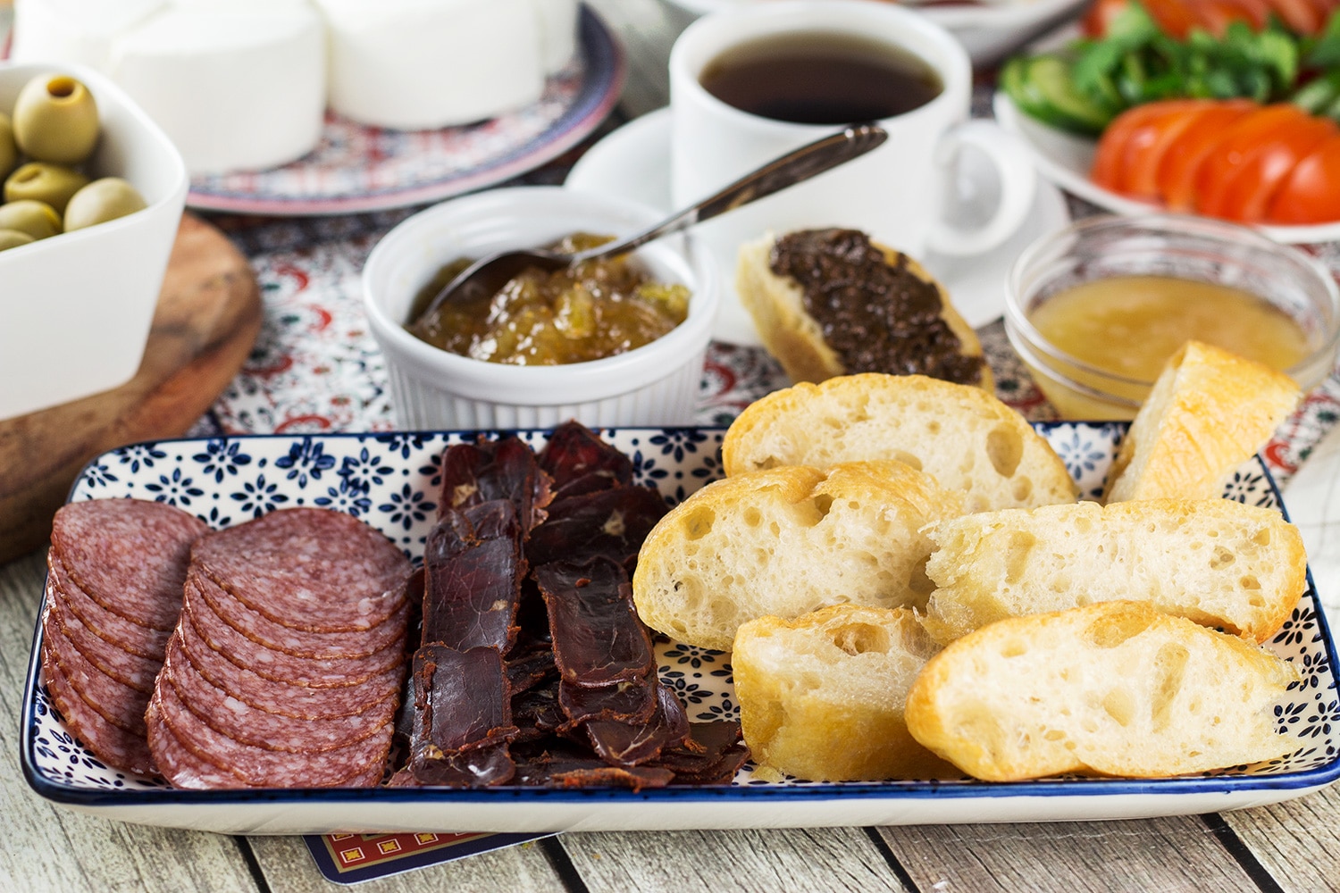 A look at the generous Turkish breakfast which features fresh bread, pastries, cold cuts, eggs, spreads, jams, cheese, veggies, and more! | cookingtheglobe.com