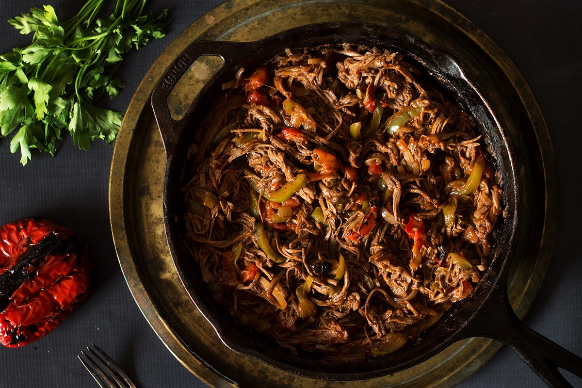 Amazingly tasty authentic Cuban Ropa Vieja recipe. Carribean aroma in your kitchen! #cuba #beef | cookingtheglobe.com