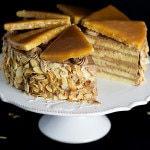 This amazing Hungarian layer cake called Dobos Torte has a fantastic buttery chocolate frosting and crazy caramel topping. Perfect for birthdays! #cake #hungary #chocolate #buttercream | cookingtheglobe.com