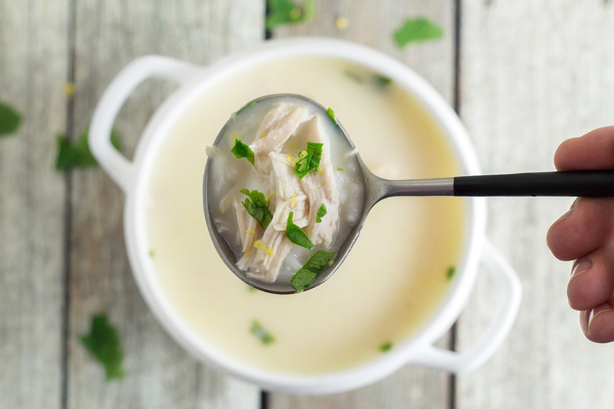 This Greek lemon rice soup, called Avgolemono, is both light and creamy. It will brighten your day! #soup #lemon #chicken | cookingtheglobe.com