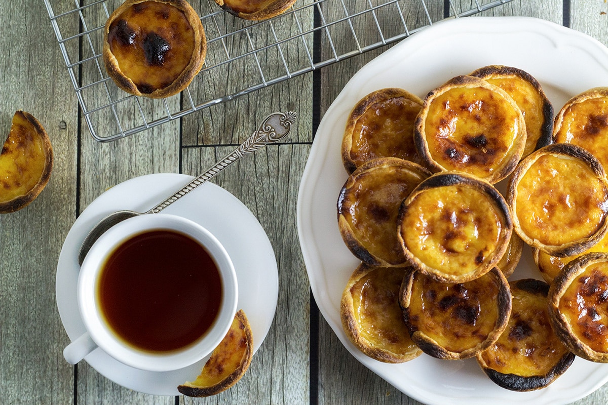 These flaky and creamy Portuguese egg tarts, called Pastel de Nata are melt-in-your-mouth good! | cookingtheglobe.com