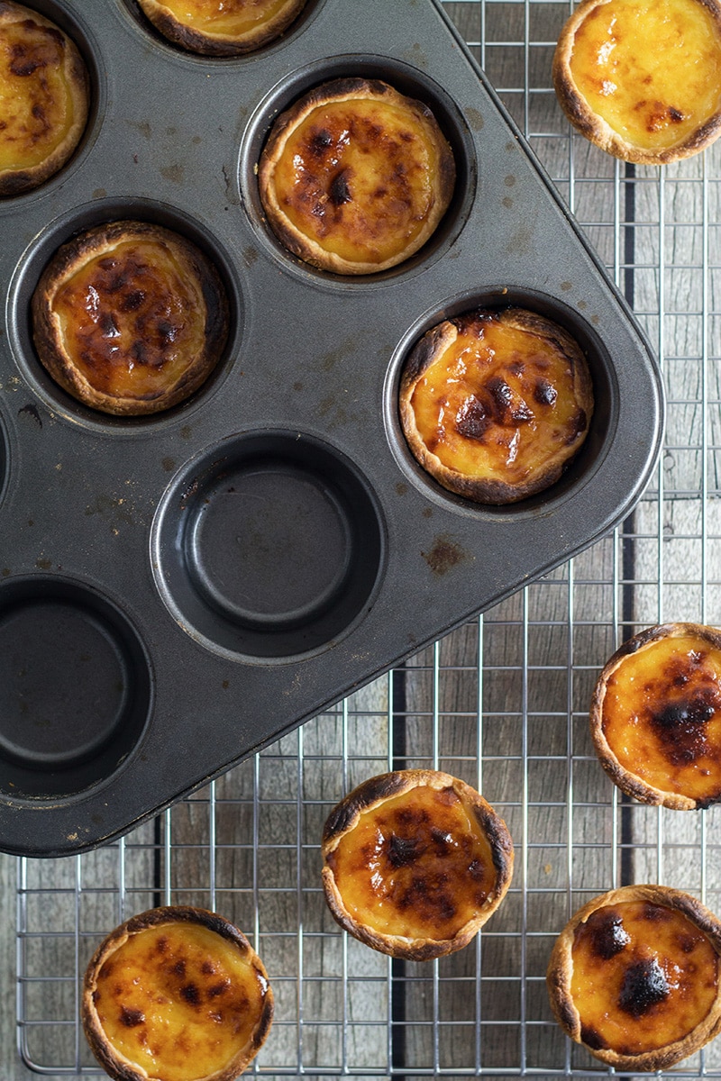 These flaky and creamy Portuguese egg tarts, called Pastel de Nata are melt-in-your-mouth good! | cookingtheglobe.com