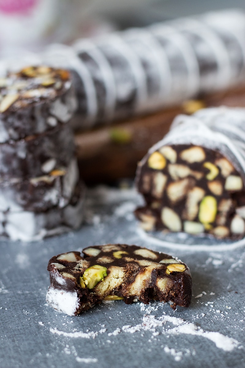 This chocolate dessert called Chocolate Salami comes straight from Italy and is filled with the flavors of chocolate, pistachios, almonds and rum! | cookingtheglobe.com