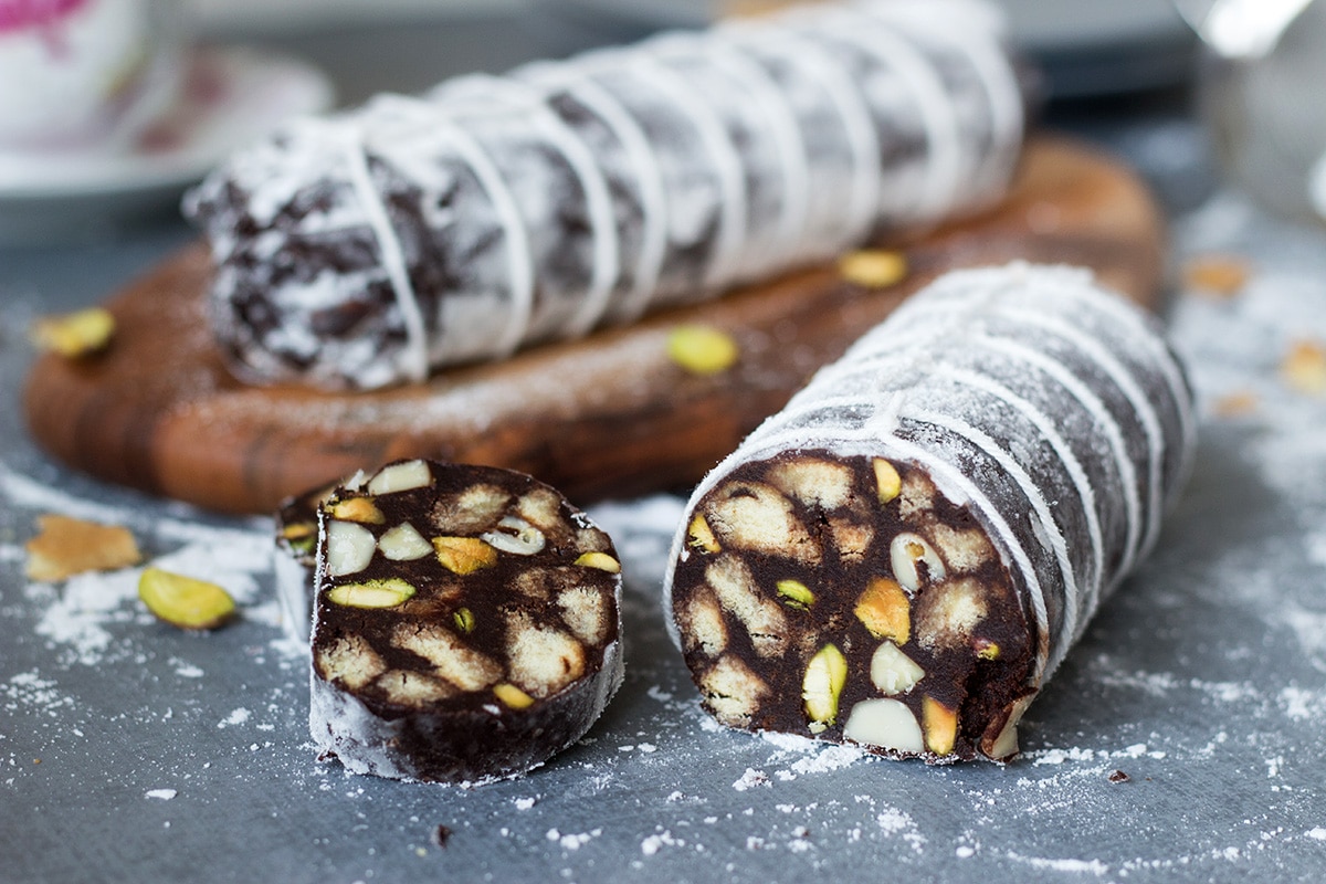 This chocolate dessert called "Chocolate Salami" comes straight from Italy and is filled with the flavors of chocolate, pistachios, almonds and rum! | cookingtheglobe.com