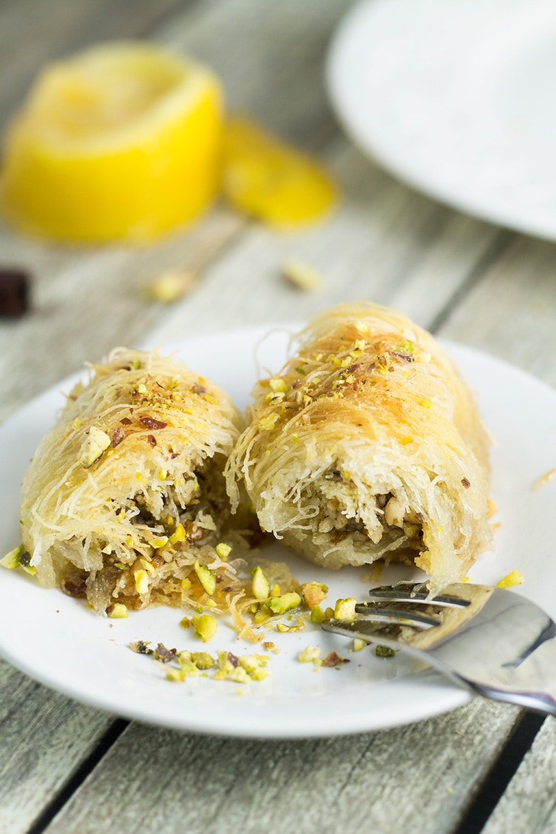 This Greek dessert called Kataifi is filled with nuts and soaked in the honey syrup. It is perfect for impressing the guests! | cookingtheglobe.com