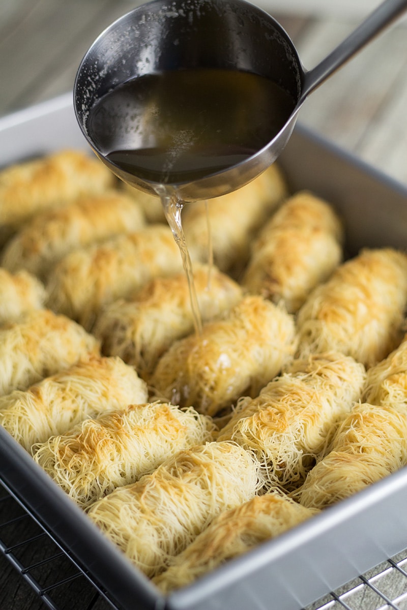 This Greek dessert called Kataifi is filled with nuts and soaked in the honey syrup. It is perfect for impressing the guests! | cookingtheglobe.com