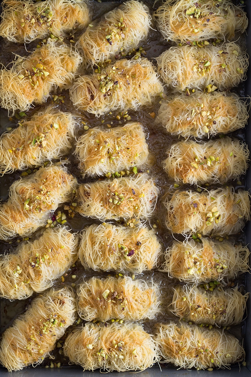 This Greek dessert called Kataifi is filled with nuts and soaked in the honey syrup. It is perfect for impressing the guests! | cookingtheglobe.com