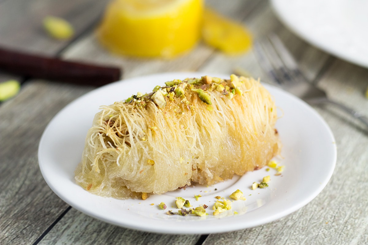 This Greek dessert called Kataifi is filled with nuts and soaked in the honey syrup. It is perfect for impressing the guests! | cookingtheglobe.com