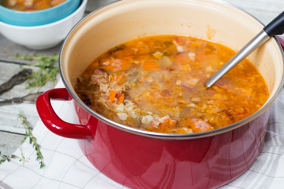 Try this hearty, warming and energizing Polish Sauerkraut Soup with sausage and bacon! | cookingtheglobe.com