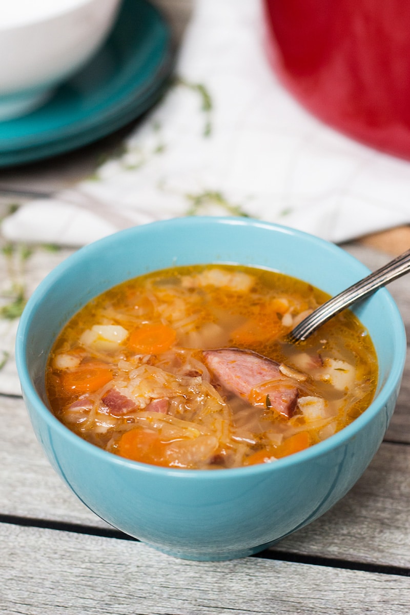 Try this hearty, warming and energizing Polish Sauerkraut Soup with sausage and bacon! | cookingtheglobe.com