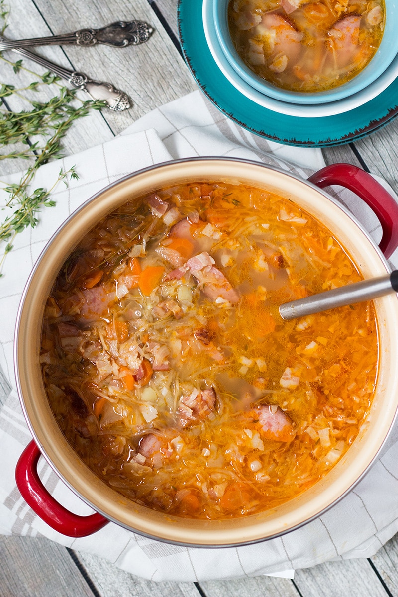 Try this hearty, warming and energizing Polish Sauerkraut Soup with sausage and bacon! | cookingtheglobe.com