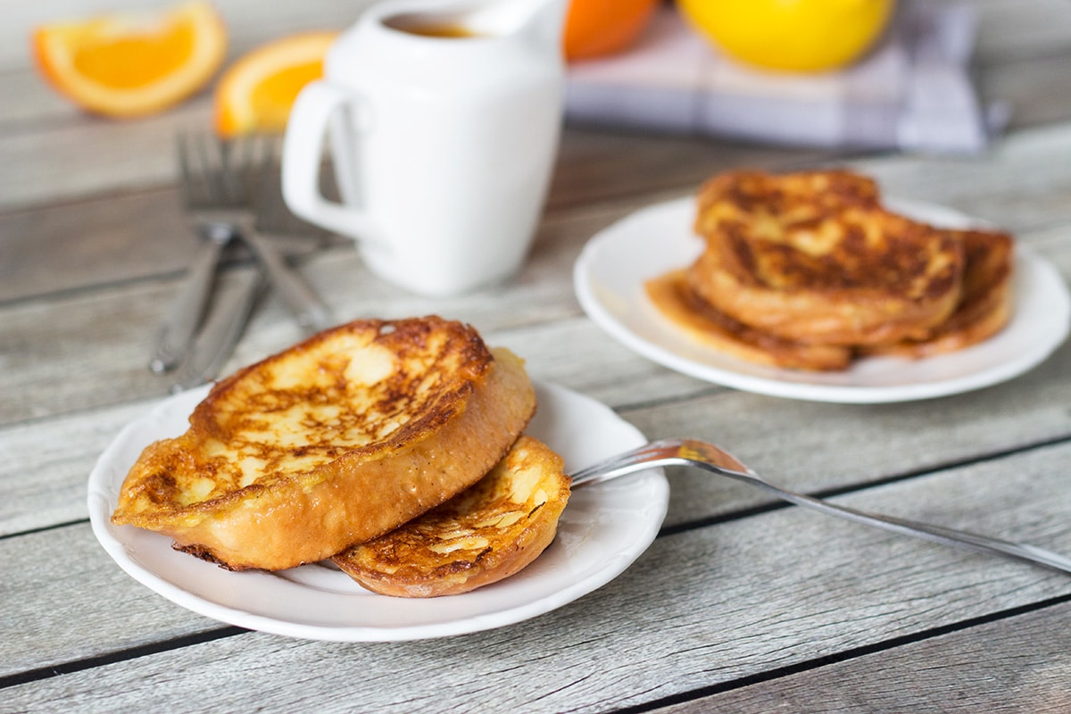 These sweet Spanish toasts, called Torrijas, are soaked in milk and drizzled with an orange-brandy syrup! | cookingtheglobe.com