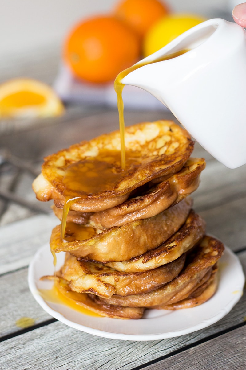 These sweet Spanish toasts, called Torrijas, are soaked in milk and drizzled with an orange-brandy syrup! | cookingtheglobe.com