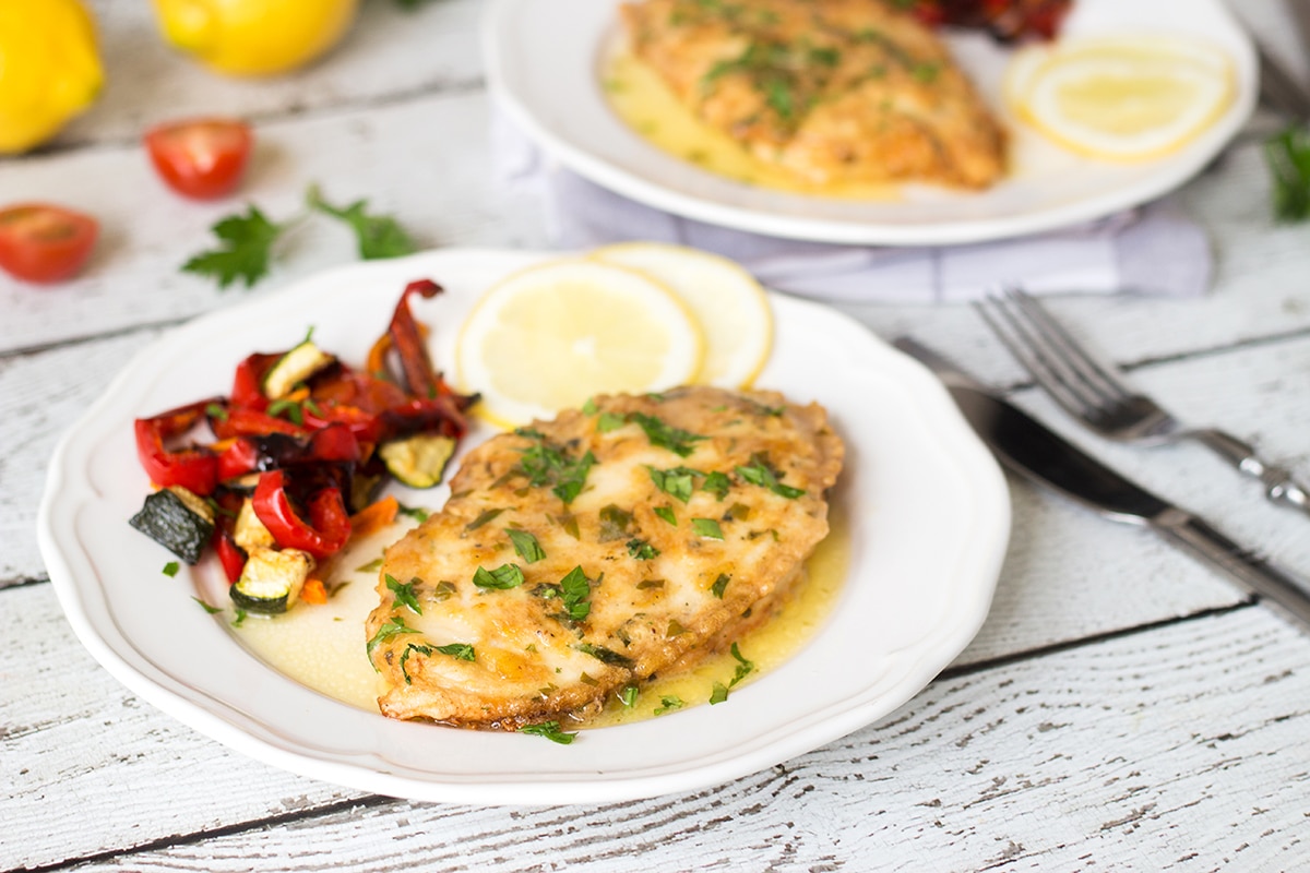 Chicken Francaise is an Italian-American dish consisting of cooked chicken breast cutlets with lemon wine sauce! | cookingtheglobe.com