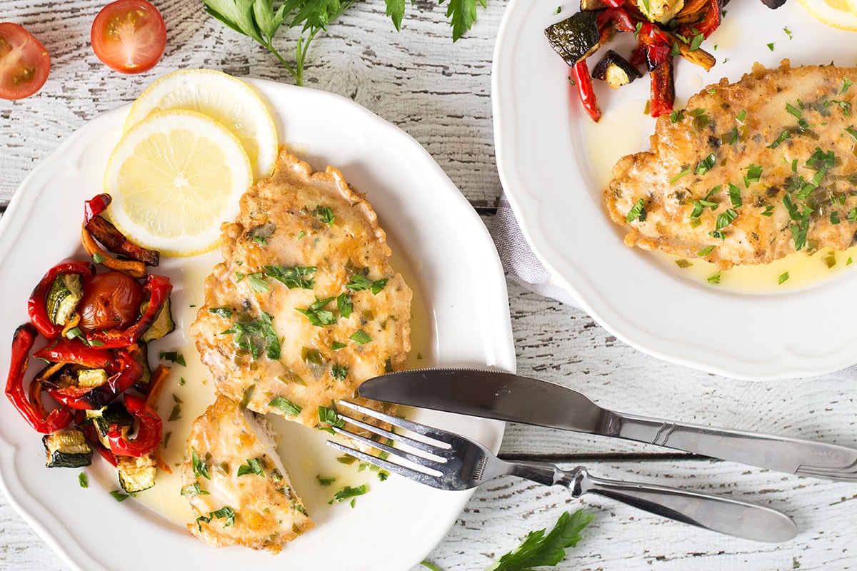 Chicken Francaise is an Italian-American dish consisting of cooked chicken breast cutlets with lemon wine sauce! | cookingtheglobe.com