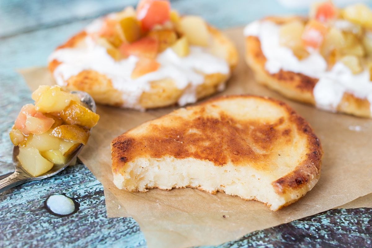 These Cottage Cheese Pancakes come from Russia and are called Syrniki. Served with sour cream and caramelized fruit! | cookingtheglobe.com