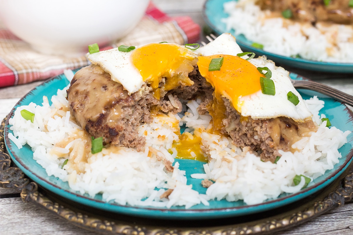 Loco Moco is a popular Hawaiian dish consisting of rice topped with a hamburger patty, fried egg, and drown in a delicious brown gravy!