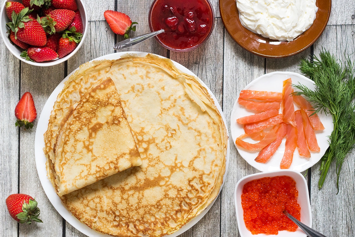 Try these Russian Pancakes (Blini) with savory (caviar & salmon) and sweet (strawberry jam) versions! | cookingtheglobe.com