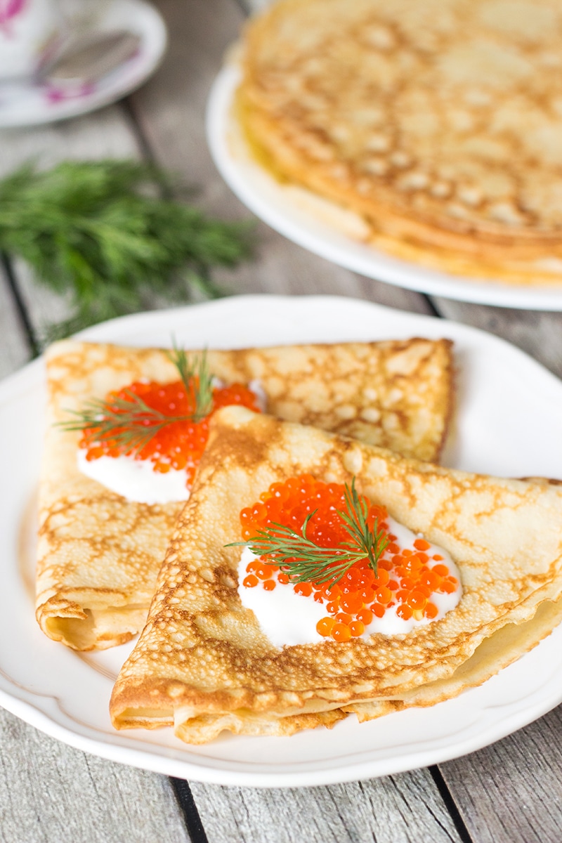 Try these Russian Pancakes (Blini) with savory (caviar & salmon) and sweet (strawberry jam) versions! | cookingtheglobe.com