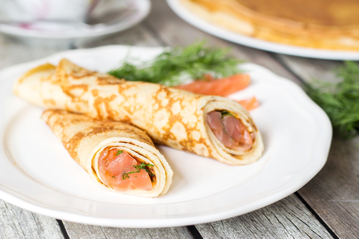 Try these Russian Pancakes (Blini) with savory (caviar & salmon) and sweet (strawberry jam) versions! | cookingtheglobe.com