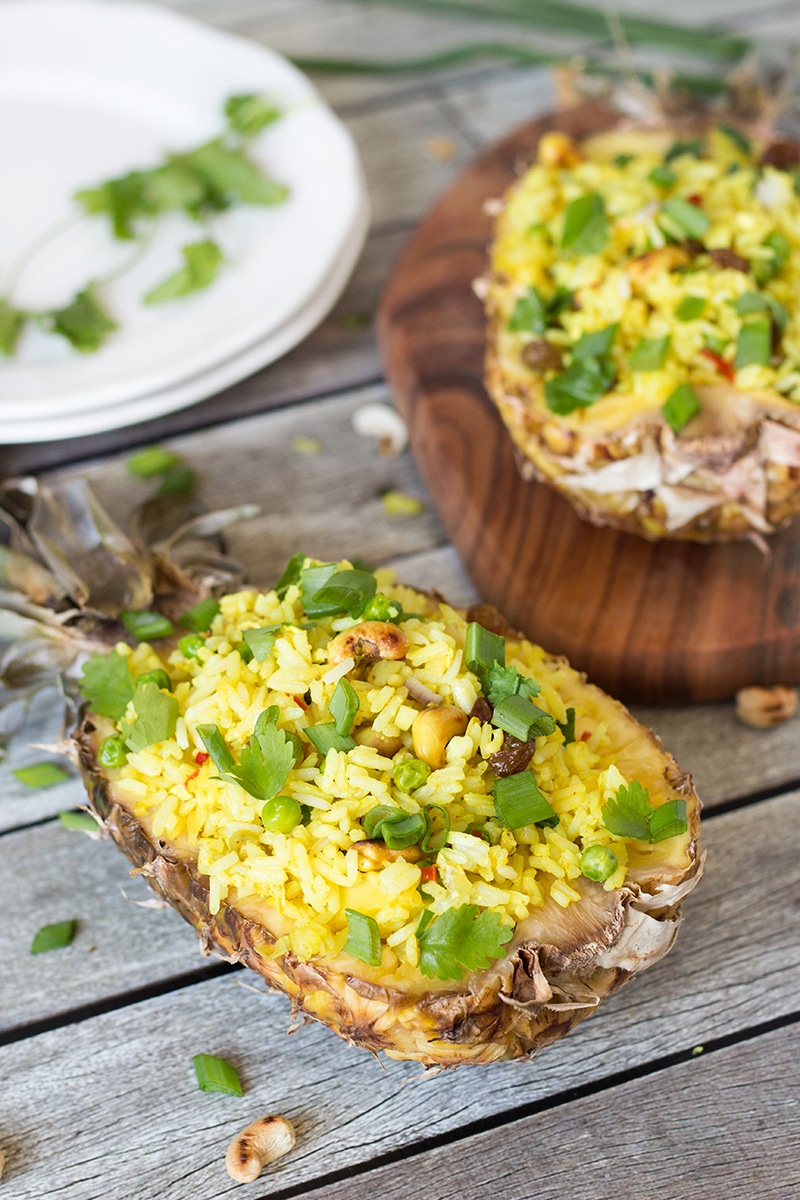 This signature Thai Pineapple Fried Rice is sweet & spicy. It is served in pineapple shells! | cookingtheglobe.com