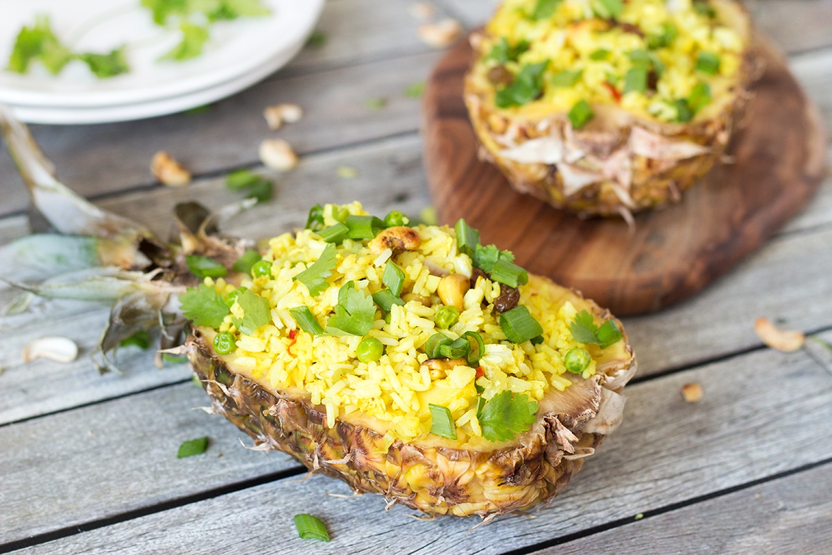 This signature Thai Pineapple Fried Rice is sweet & spicy. It is served in pineapple shells! | cookingtheglobe.com