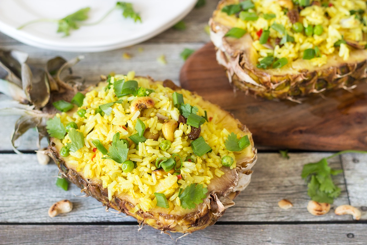 This signature Thai Pineapple Fried Rice is sweet & spicy. It is served in pineapple shells! | cookingtheglobe.com