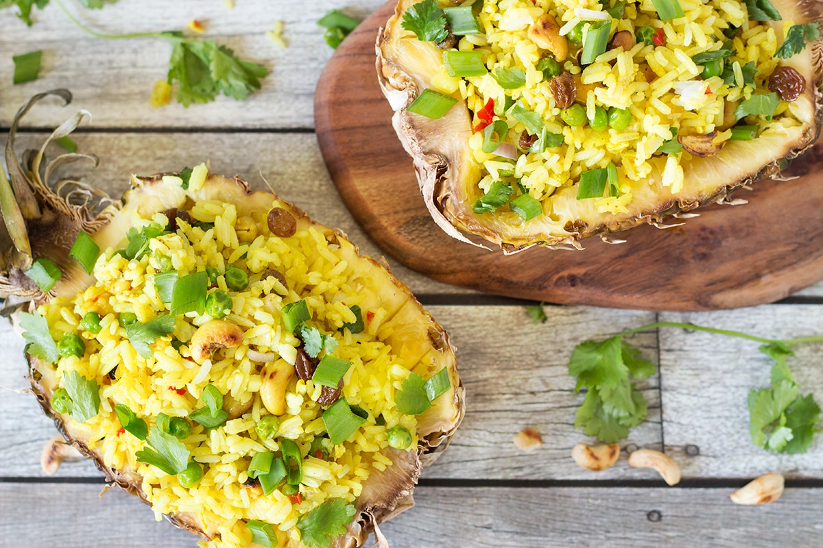 This signature Thai Pineapple Fried Rice is sweet & spicy. It is served in pineapple shells! | cookingtheglobe.com