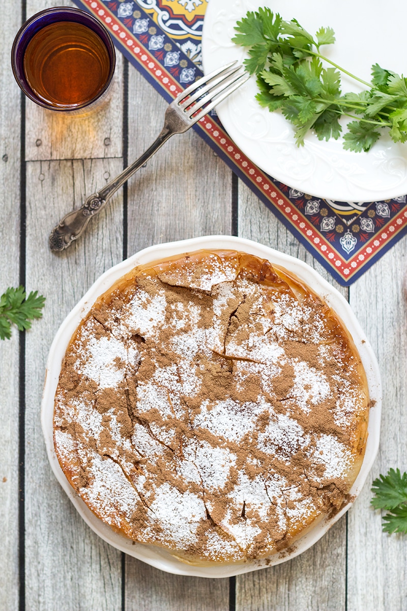 This sweet & savory Moroccan Pie (Pastilla) has a crisp, flaky pastry outside and an amazing cinnamon flavored chicken, onion, and almond filling inside!