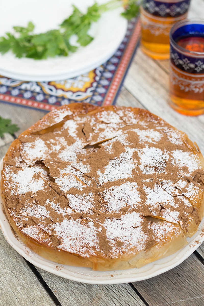 This sweet & savory Moroccan Pie (Pastilla) has a crisp, flaky pastry outside and an amazing cinnamon flavored chicken, onion, and almond filling inside!