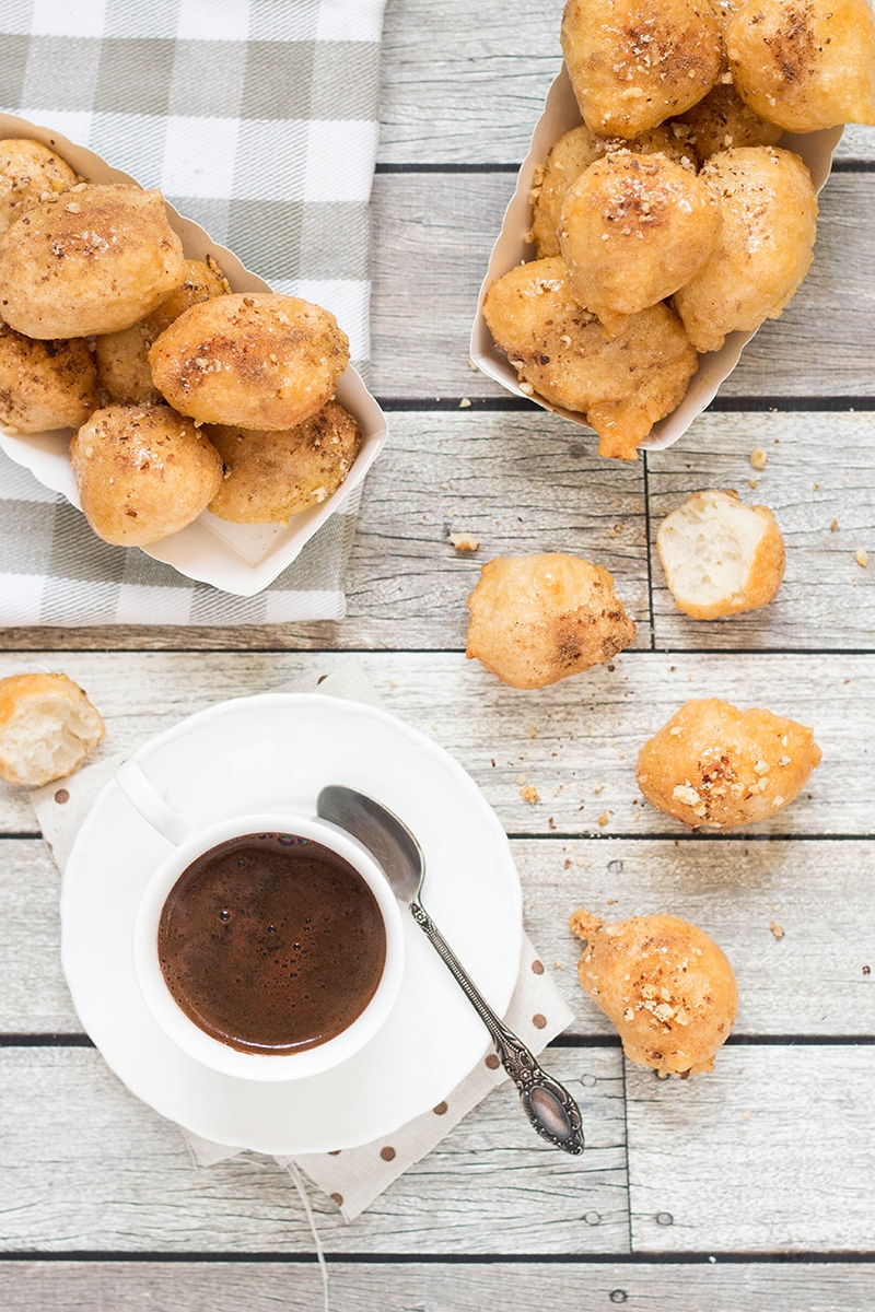 Check out these traditional Greek honey puffs (Loukoumades) sprinkled with cinnamon and walnuts. They are also called Greek donuts. Heaven for your taste buds!