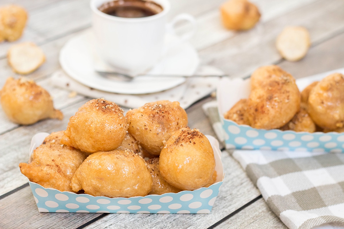 Check out these traditional Greek honey puffs (Loukoumades) sprinkled with cinnamon and walnuts. They are also called Greek donuts. Heaven for your taste buds!