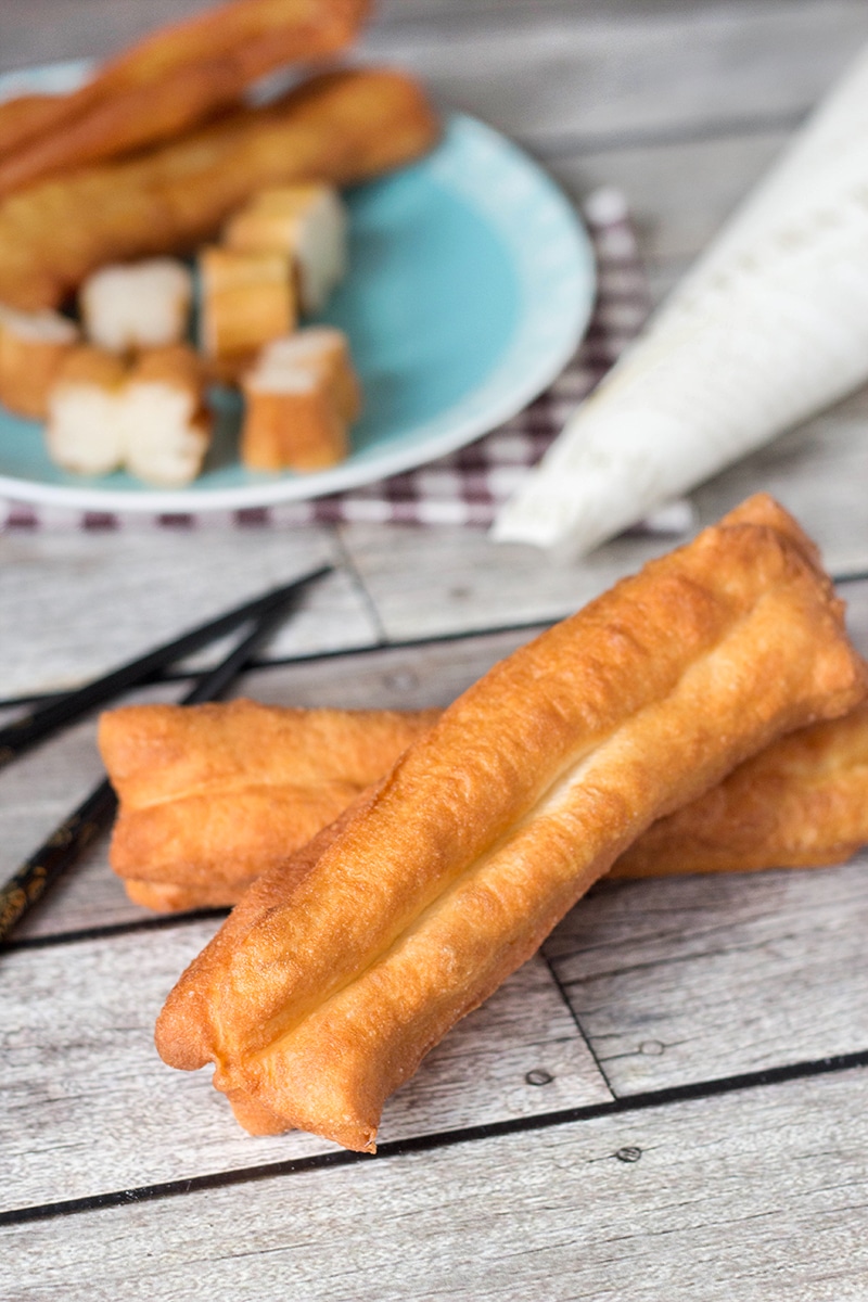 These Chinese Crullers, or Chinese donuts, called Youtiao, are a traditional breakfast staple in China. They can be enjoyed as a standalone dish or dipped in a warm soy milk! | cookingtheglobe.com