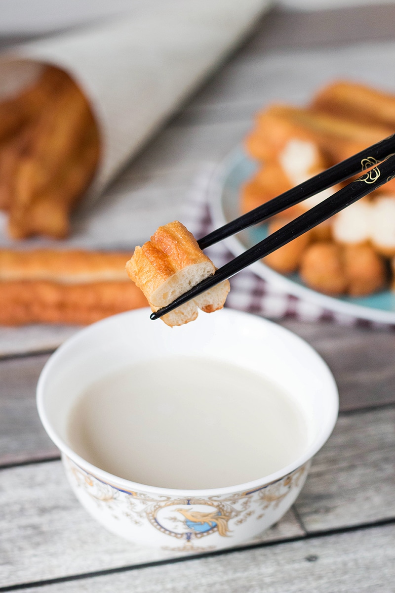 These Chinese Crullers, or Chinese donuts, called Youtiao, are a traditional breakfast staple in China. They can be enjoyed as a standalone dish or dipped in a warm soy milk! | cookingtheglobe.com