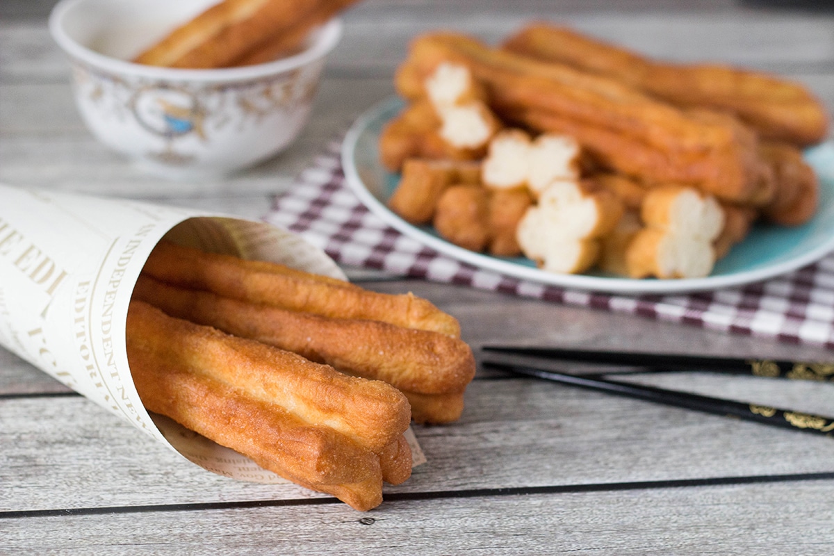 These Chinese Crullers, or Chinese donuts, called Youtiao, are a traditional breakfast staple in China. They can be enjoyed as a standalone dish or dipped in a warm soy milk! | cookingtheglobe.com