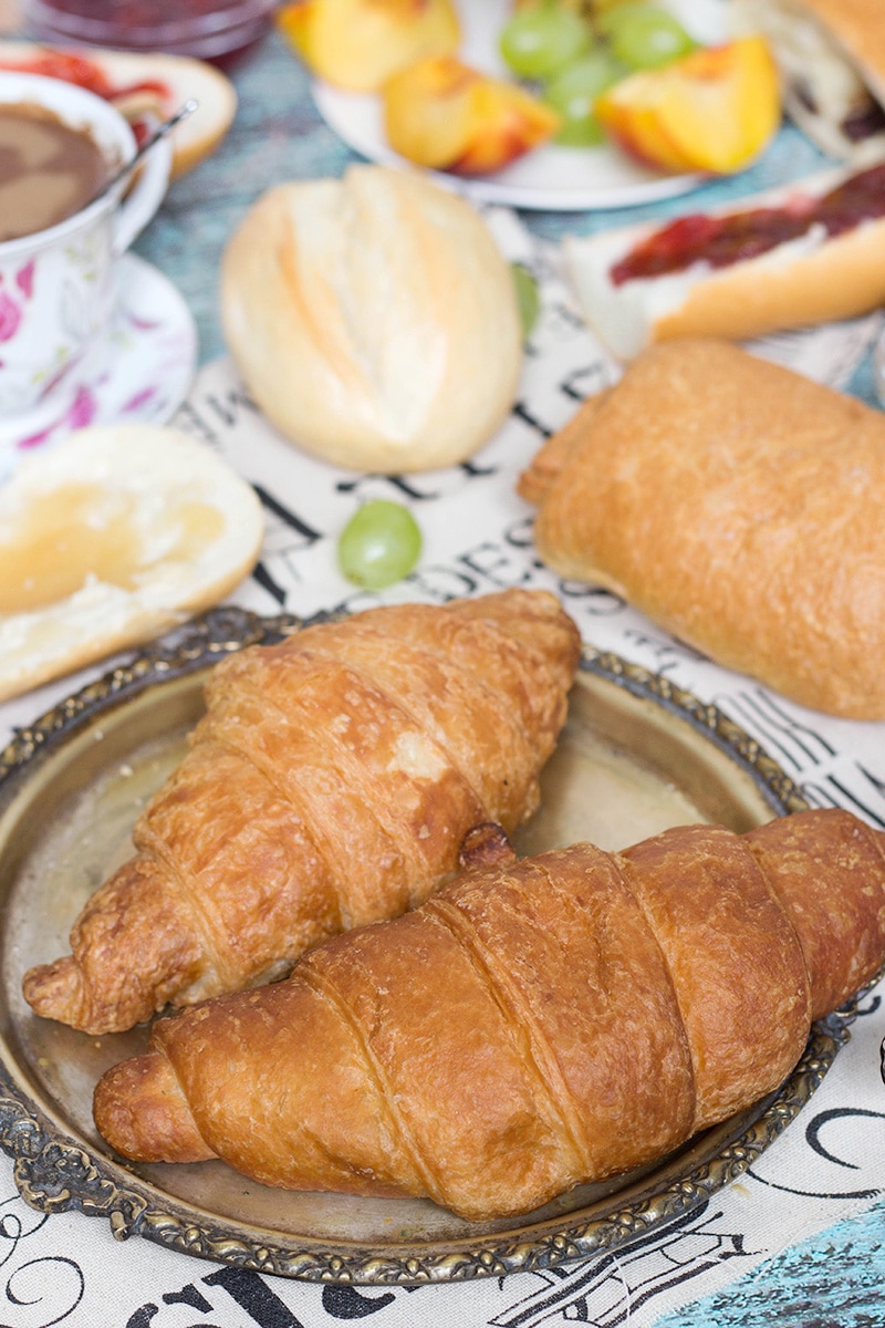 A look at the famous French breakfast, featuring a selection of breads and toppings, croissants, Pain au chocolat, and other goodies! | cookingtheglobe.com