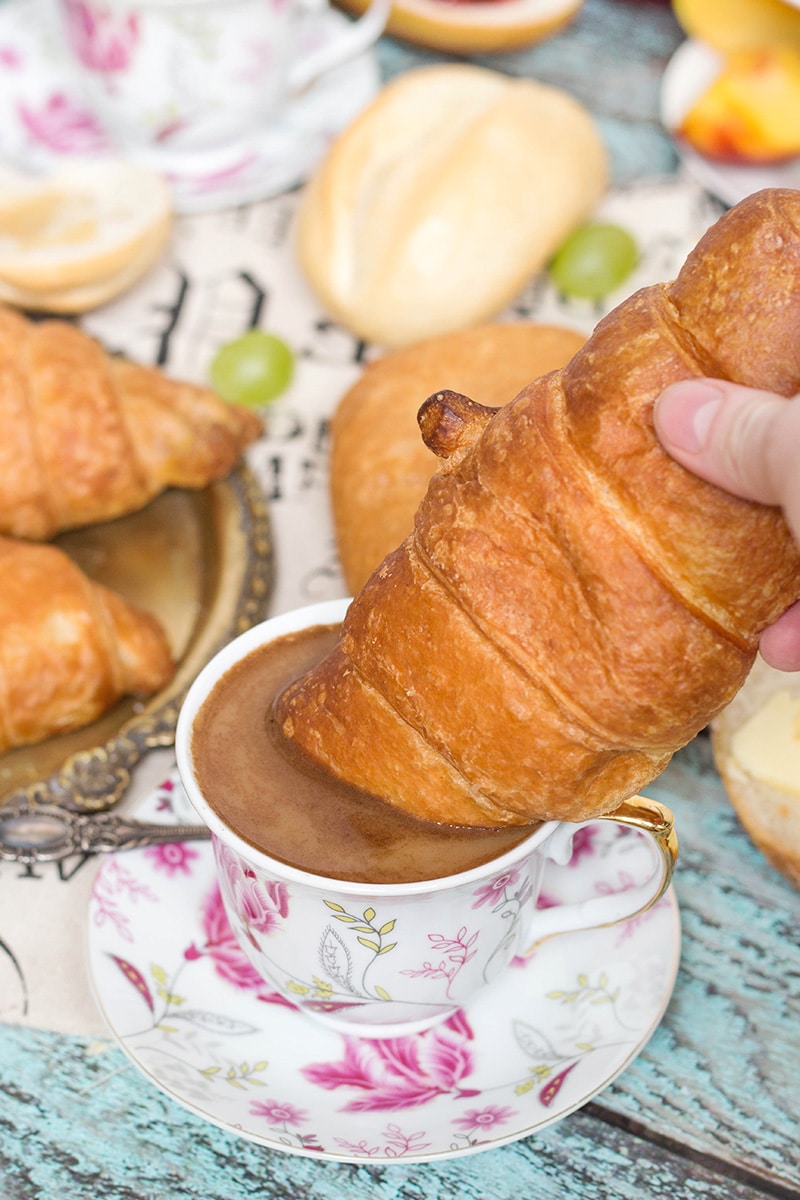 French breakfast with croissant, berries, jam and black coffee