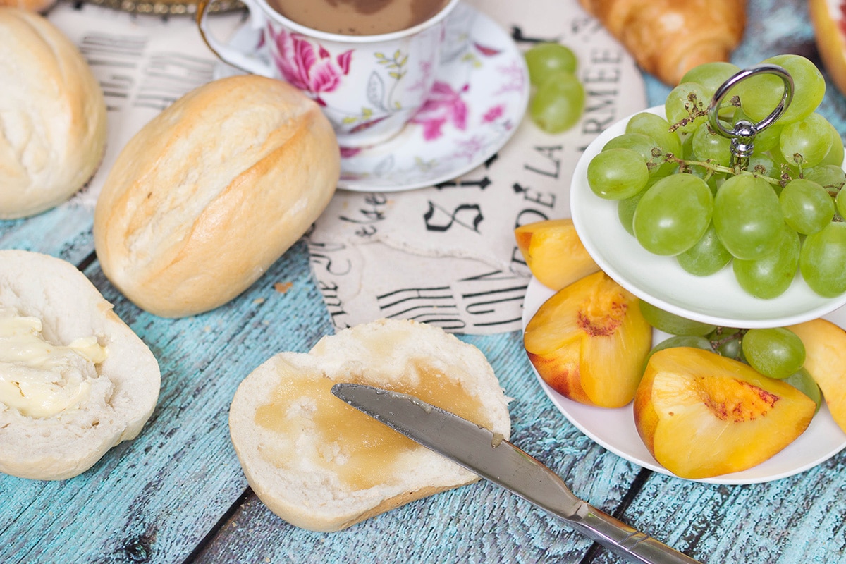 A look at the famous French breakfast, featuring a selection of breads and toppings, croissants, Pain au chocolat, and other goodies! | cookingtheglobe.com