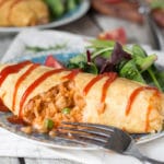 Omurice is a Japanese dish which got its name from a combo of words "omelette" and "rice". Basically, it's ketchup flavored rice cooked with chicken, peas, and wrapped in a thin crepe-like omelette. Pure heaven! | cookingtheglobe.com