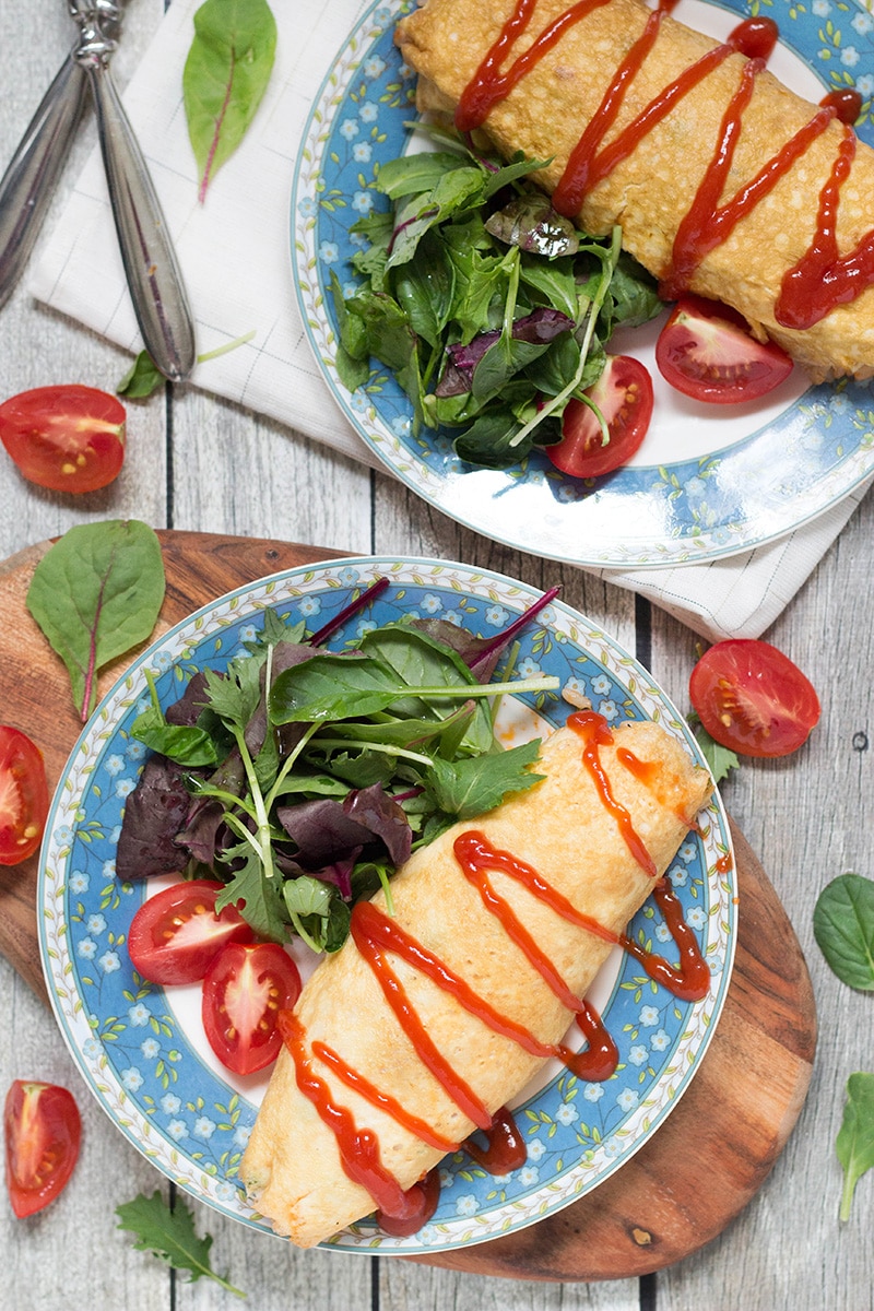 Omurice is a Japanese dish which got its name from a combo of words "omelette" and "rice". Basically, it's ketchup flavored rice cooked with chicken, peas, and wrapped in a thin crepe-like omelette. Pure heaven! | cookingtheglobe.com