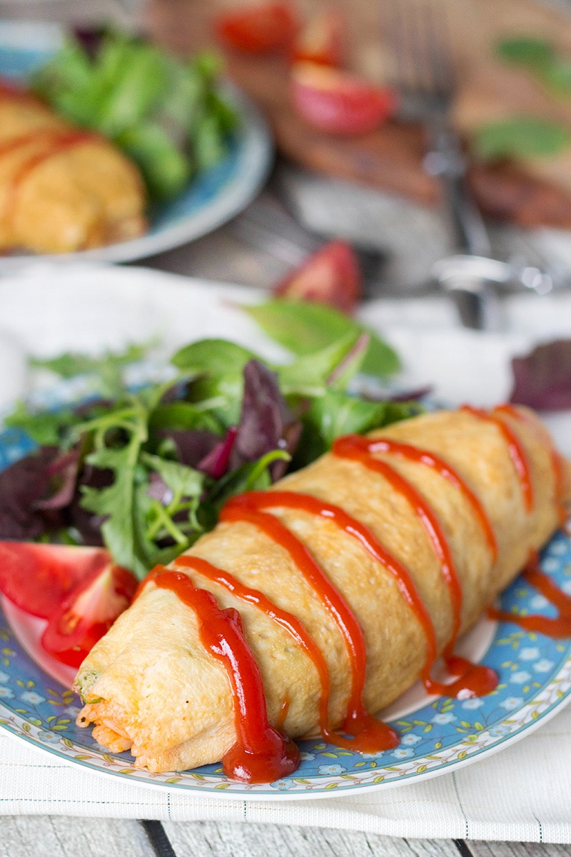 Omurice is a Japanese dish which got its name from a combo of words "omelette" and "rice". Basically, it's ketchup flavored rice cooked with chicken, peas, and wrapped in a thin crepe-like omelette. Pure heaven! | cookingtheglobe.com