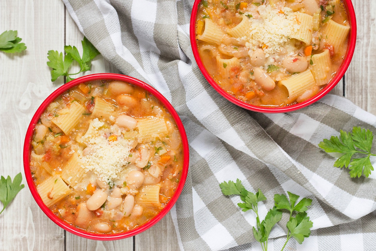 Pasta Fazool, also known by the name Pasta e Fagioli, is a classic Italian pasta and bean soup. It also features Parmesan cheese, tomatoes, and tons of other veggies! | cookingtheglobe.com