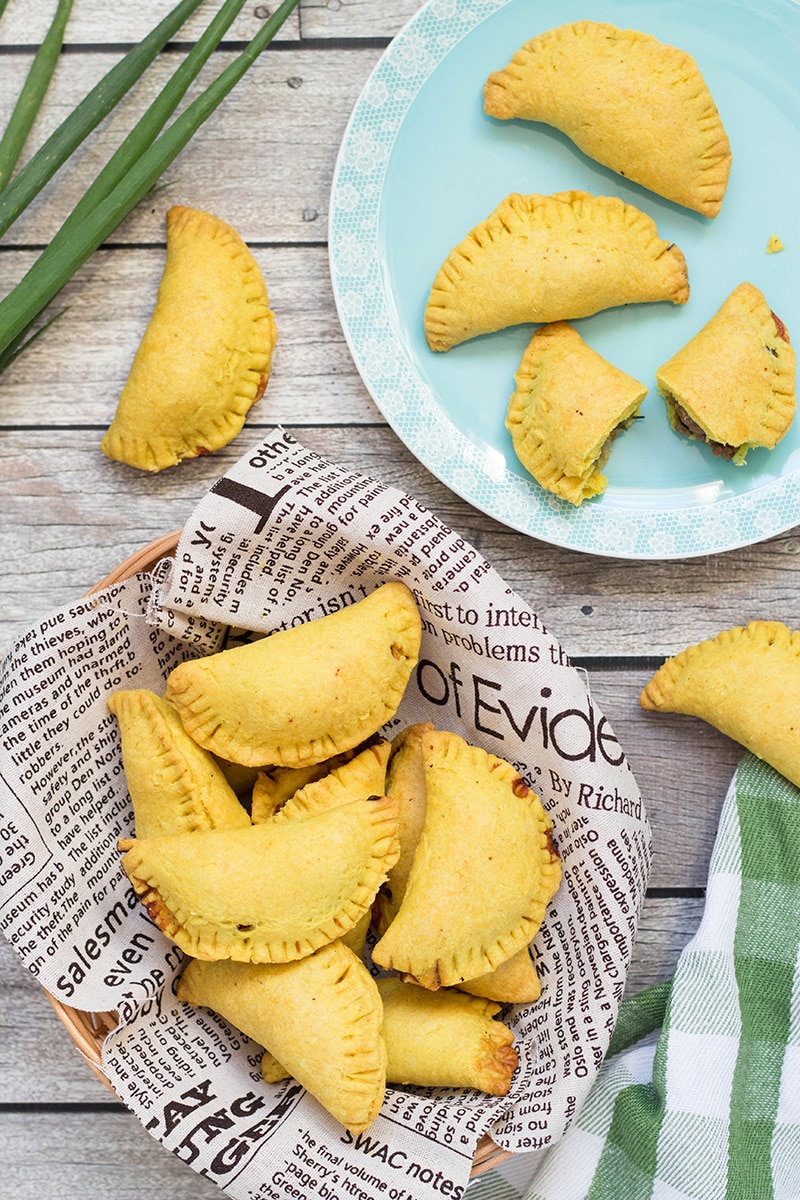 These flaky Jamaican Beef Patties are filled with a spicy ground beef mixture flavored with onion, thyme, pepper, and curry. Perfect on-the-go snack any time of the day! | cookingtheglobe.com