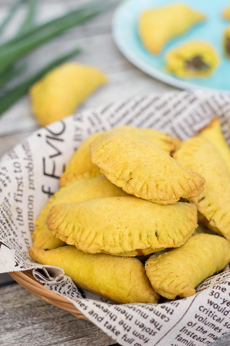 These flaky Jamaican Beef Patties are filled with a spicy ground beef mixture flavored with onion, thyme, pepper, and curry. Perfect on-the-go snack any time of the day! | cookingtheglobe.com