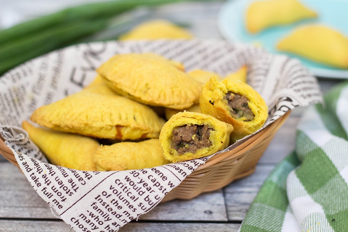 These flaky Jamaican Beef Patties are filled with a spicy ground beef mixture flavored with onion, thyme, pepper, and curry. Perfect on-the-go snack any time of the day! | cookingtheglobe.com