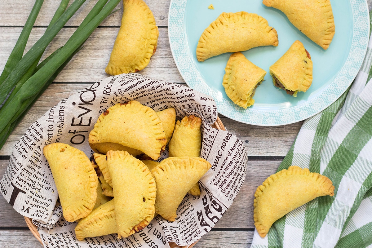 These flaky Jamaican Beef Patties are filled with a spicy ground beef mixture flavored with onion, thyme, pepper, and curry. Perfect on-the-go snack any time of the day! | cookingtheglobe.com