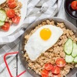 Indonesian Fried Rice (Nasi Goreng) is one of the most popular Indonesian dishes. It features chicken, tons of veggies, and is served with a fried egg on top! | cookingtheglobe.com