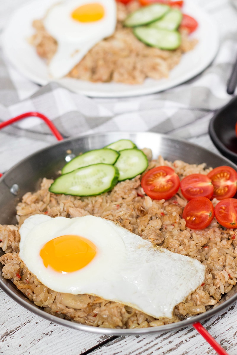 Indonesian Fried Rice (Nasi Goreng) is one of the most popular Indonesian dishes. It features chicken, tons of veggies, and is served with a fried egg on top! | cookingtheglobe.com