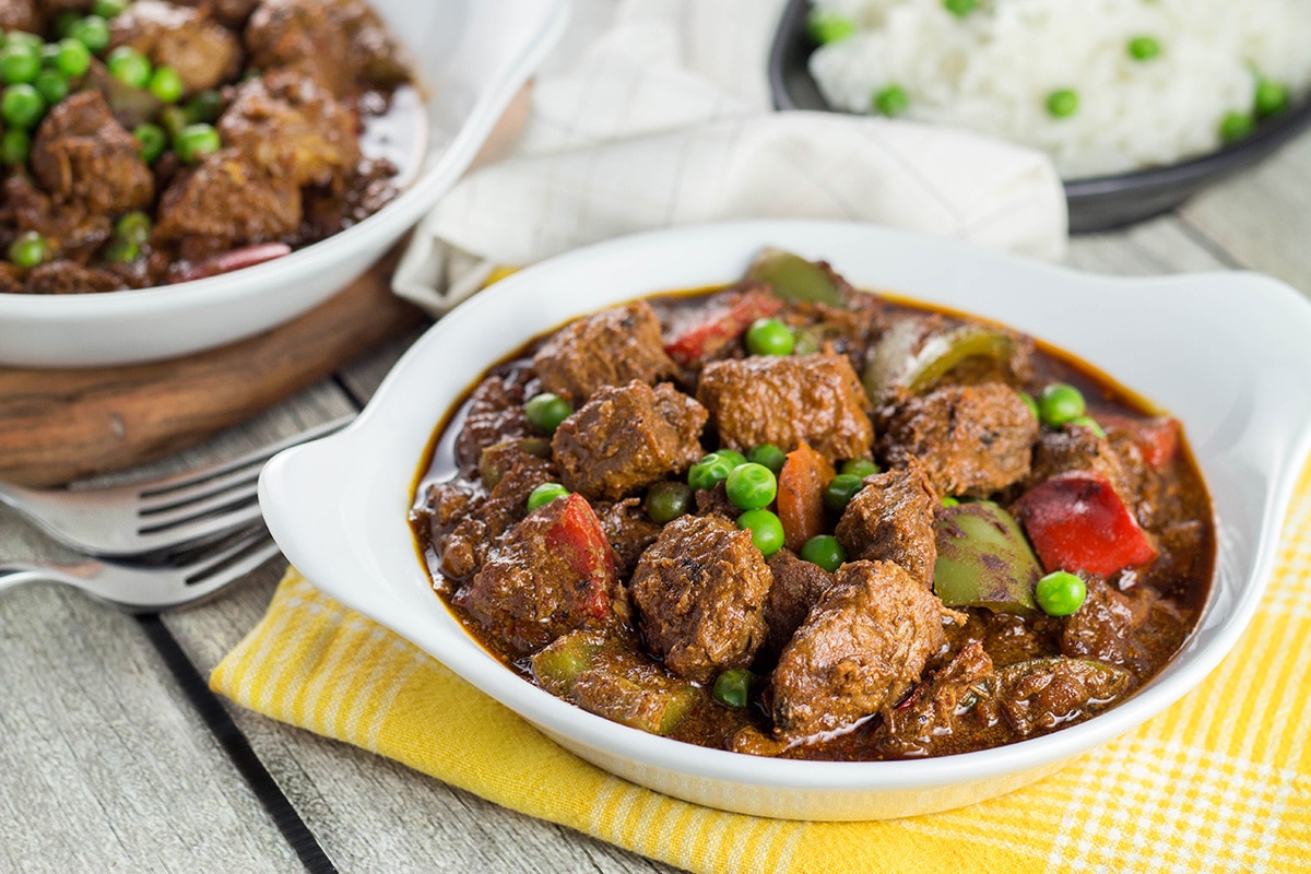 Beef Caldereta is a tomato sauce, red wine, and soy sauce based stew coming from the Philippines. But what sets it apart from other stews is the addition of liver pâté! Intrigued? Check it out! | cookingtheglobe.com